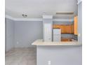 Open kitchen with light wood cabinets, breakfast bar, and gray walls at 8848 Villa View # 106, Orlando, FL 32821