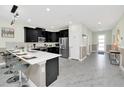 Open concept kitchen with island seating and stainless steel appliances at 9194 Sommerset Hills Dr, Davenport, FL 33896