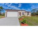 Charming single-story home with a well-manicured lawn, tidy landscaping, and a driveway at 9505 Luna Dr, St Cloud, FL 34773