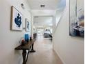 Spacious entryway with tile floors and art pieces, leading to the living area at 993 Suffolk Pl, Davenport, FL 33896