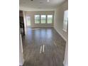 Spacious living area with grey tile flooring and large windows at 1144 Trappers Trail Loop, Davenport, FL 33896