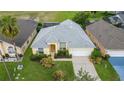 House with a gray roof and a pool in the backyard at 135 Langham Dr, Davenport, FL 33897