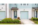 Townhome's front entrance with a blue door and attached garage at 1481 Discovery St, Davenport, FL 33896