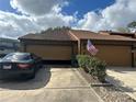 Condo garage with an open garage door and American flag at 156 Lakewood Village Cir # 156, Daytona Beach, FL 32119