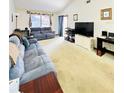 Bright living room featuring a large TV and ample seating at 156 Lakewood Village Cir # 156, Daytona Beach, FL 32119