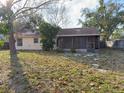 This home includes a large backyard with a screened in porch at 1823 Natchez Trace Blvd, Orlando, FL 32818