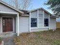 Exterior shot of a home's facade, focusing on the front door and surrounding windows at 1823 Natchez Trace Blvd, Orlando, FL 32818