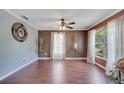 Living room featuring hardwood floors, natural light, neutral paint, and stylish ceiling fan at 212 Rontunda Dr, Kissimmee, FL 34758
