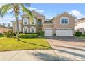 Two-story house with a three-car garage and solar panels at 2136 Laurel Blossom Cir, Ocoee, FL 34761
