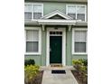 Green front door with white trim and a small welcome mat at 2200 San Christabolo Dr # 106, Kissimmee, FL 34741