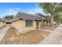 Side view of tan house with gray roof and landscaping at 2223 Silver Pines Pl # 501, Orlando, FL 32808