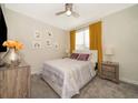 Bright bedroom with mustard yellow curtains and wood nightstands at 2746 Bookmark Dr, Kissimmee, FL 34746