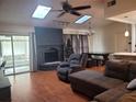 Comfortable living room with a brick fireplace, skylights, and ample seating at 4749 Hopespring Dr, Orlando, FL 32829