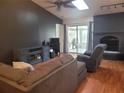 Open living room featuring a brick fireplace and sliding glass doors to the patio at 4749 Hopespring Dr, Orlando, FL 32829
