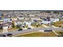 Aerial view of a residential neighborhood with many houses and solar panels at 583 Taft Dr, Davenport, FL 33837