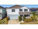 Two-story house with gray siding, stone accents, and a two-car garage at 583 Taft Dr, Davenport, FL 33837