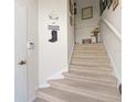 Staircase with carpeted steps leading to upper level at 7137 Harmony Square Dr # 31A, Harmony, FL 34773