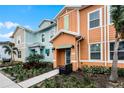 Attractive townhouses showcasing a colorful design and neatly landscaped front yards at 8178 Coconut Pl, Kissimmee, FL 34747