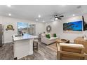 Open living space with modern furniture, hardwood floors, and beachy decor at 8178 Coconut Pl, Kissimmee, FL 34747
