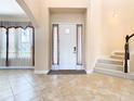 Bright and spacious entryway with tile flooring and staircase at 880 Spinnaker Way, Kissimmee, FL 34746