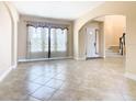 Open living area with tile floors and access to entryway at 880 Spinnaker Way, Kissimmee, FL 34746