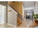 Elegant staircase connecting the entryway to the upper level of the home at 8963 Coco Palm Rd, Kissimmee, FL 34747