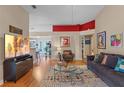 Bright living room with hardwood floors, comfy seating, and a view into the kitchen at 102 Circle Hill Rd, Sanford, FL 32773