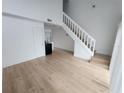 Spacious living room with wood-look floors and staircase at 10232 Turkey Lake Rd # 181, Orlando, FL 32819