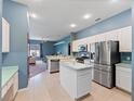 Modern kitchen with stainless steel appliances and blue walls at 103 Vega Ct, Davenport, FL 33896