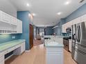 Spacious kitchen featuring stainless steel appliances and an island at 103 Vega Ct, Davenport, FL 33896