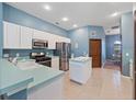 Kitchen with stainless steel appliances and an island at 103 Vega Ct, Davenport, FL 33896