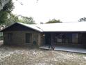 Side view of brick ranch house with backyard and trees at 1085 Old Hickory Tree Rd, St Cloud, FL 34771