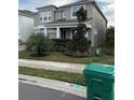 Two-story house with palm trees and a manicured lawn at 14429 Wabasso Loop, Winter Garden, FL 34787