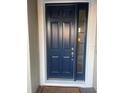 Elegant navy blue front door with sidelight at 14429 Wabasso Loop, Winter Garden, FL 34787