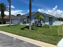 Single-story home with gray exterior, paved driveway, and lush landscaping at 148 Joewood Trl, Davenport, FL 33837