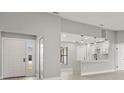 Bright entryway with white door and view into the kitchen at 202 Cobalt Dr, Kissimmee, FL 34758