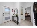 Bright and airy entryway with mirror and console table at 2461 Reading Trl, Kissimmee, FL 34746