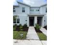 Modern two-story townhome with front yard and walkway at 2461 Reading Trl, Kissimmee, FL 34746