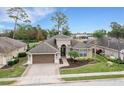 One-story house with a two-car garage and a landscaped yard at 296 Del Sol Ave, Davenport, FL 33837