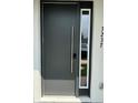 Contemporary dark gray front door with long silver handle at 3237 Energy Drive, Kissimmee, FL 34747