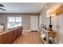 Light-filled living room with wood floors and a brown leather couch at 3316 Planter Dr, Deltona, FL 32738