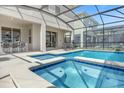 Inviting pool and spa with covered patio and lush landscaping at 4370 Rhyme St, Kissimmee, FL 34746