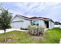 Newly built home with a spacious front yard at 505 Pentas Ln, Haines City, FL 33844