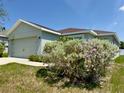 Charming single-story home featuring an attached two-car garage and manicured landscaping in a well-maintained yard at 505 Pentas Ln, Haines City, FL 33844