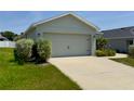 Charming single-story home featuring an attached two-car garage, landscaped front yard and a concrete driveway at 505 Pentas Ln, Haines City, FL 33844