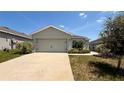 Charming single-story home featuring an attached two-car garage, landscaped front yard and a concrete driveway at 505 Pentas Ln, Haines City, FL 33844