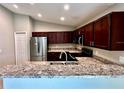 Kitchen with stainless steel appliances and granite countertops at 505 Pentas Ln, Haines City, FL 33844
