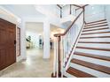 Grand entryway with a staircase and views into the dining area at 5454 Rishley Run Way, Mount Dora, FL 32757