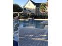 Community pool with surrounding patio and building view at 6413 Astor Village # 210, Orlando, FL 32835