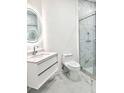 Bathroom with marble tile, floating vanity, and a large shower at 8296 Portofino Dr # 102, Davenport, FL 33896